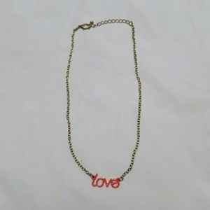Gold Necklace with Orange Love on it.